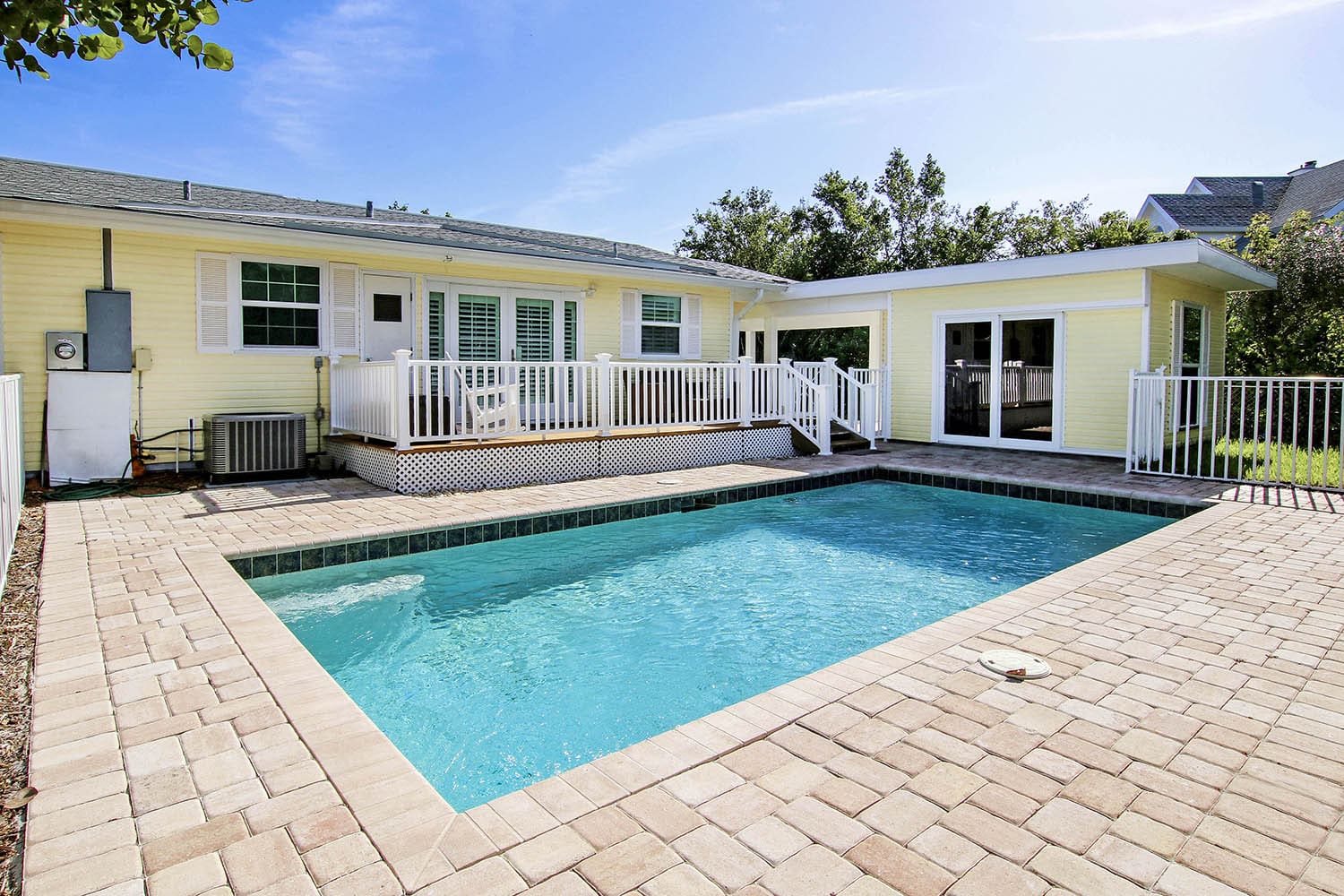 A pool that is in the middle of some kind of yard.