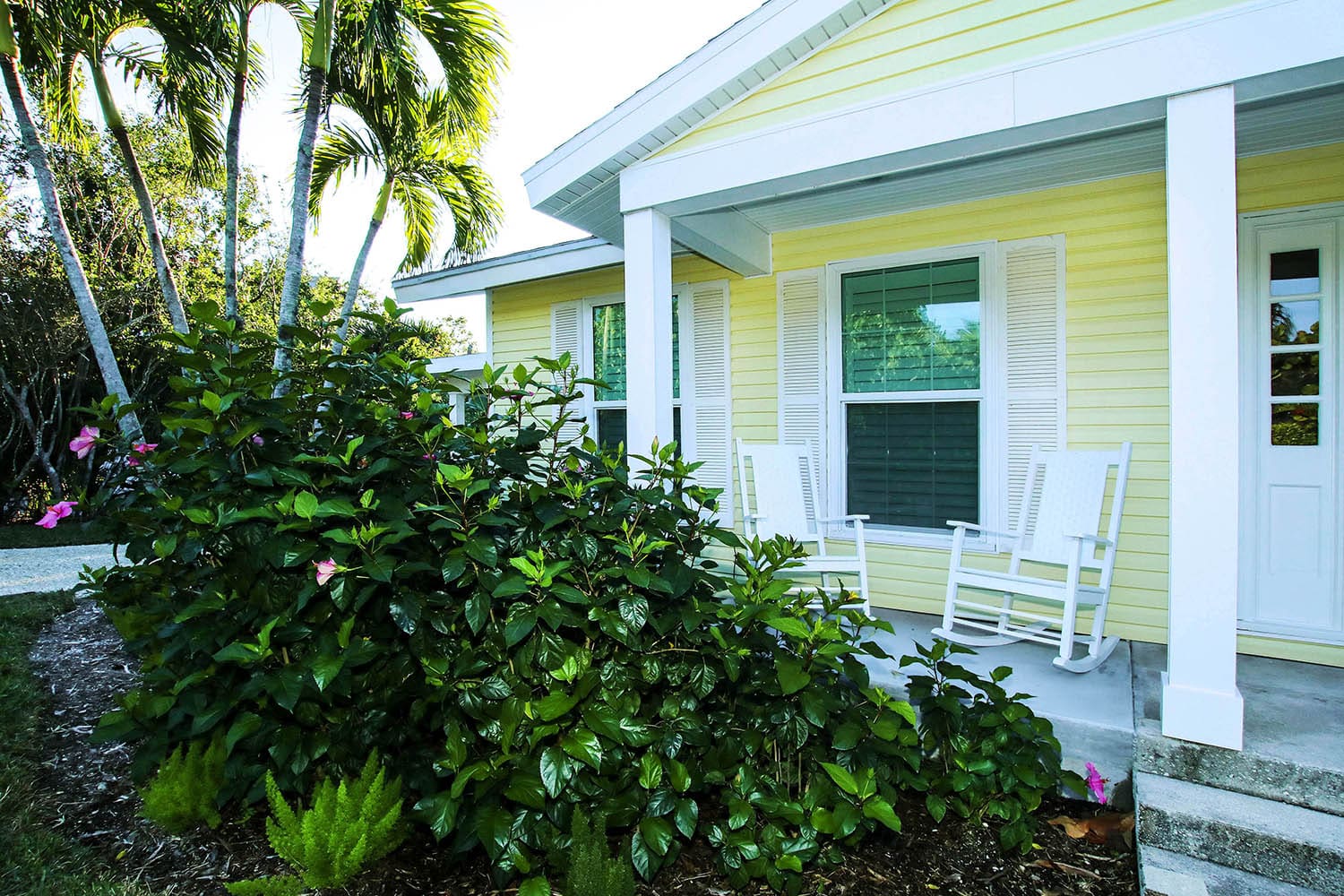 A house with yellow walls and white trim.