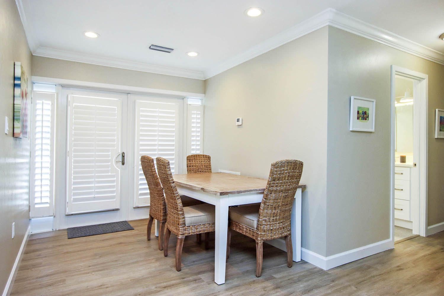 A dining room table with chairs and a door.