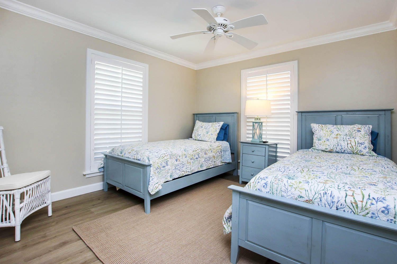 A bedroom with two beds and a dresser.