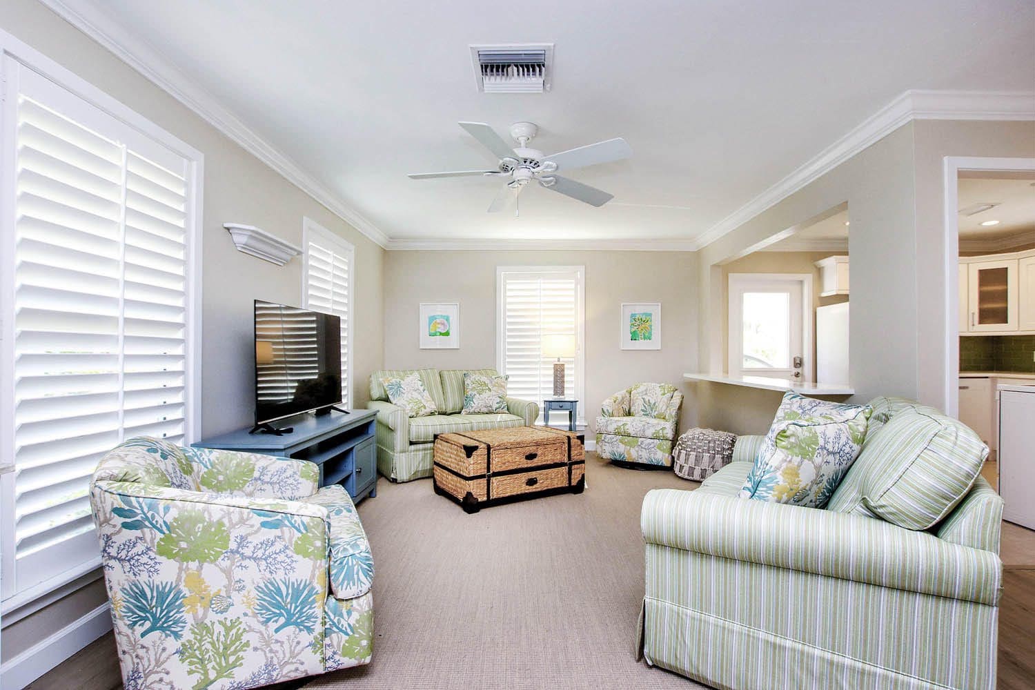 A living room with couches, chairs and television.